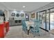 Bright dining area has table with blue chairs, grey cabinets, and sliding glass doors at 725 Briarcrest Dr, Orange City, FL 32763