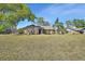 The front yard features a well-manicured lawn and brick facade adding curb appeal to the home at 725 Briarcrest Dr, Orange City, FL 32763