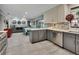 Modern kitchen features stainless steel appliances, island and sleek gray and white cabinets at 725 Briarcrest Dr, Orange City, FL 32763