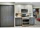 Modern kitchen with stainless steel appliances, two-tone cabinets, and an electric range at 725 Briarcrest Dr, Orange City, FL 32763