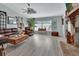 Cozy living room showcasing hard wood floors, comfortable leather seating and lots of light at 725 Briarcrest Dr, Orange City, FL 32763