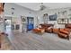 Open floor plan in the living room featuring lots of seating, hard wood floors and views to the kitchen at 725 Briarcrest Dr, Orange City, FL 32763