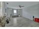 Bright and airy living room featuring a ceiling fan, bookshelves, and large window at 725 Briarcrest Dr, Orange City, FL 32763