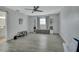 Bright and airy living room featuring a ceiling fan, bookshelves, and large window at 725 Briarcrest Dr, Orange City, FL 32763