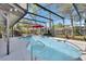 A screened-in pool and spa area features a dark mesh, gray deck, red umbrella, and bright blue water at 725 Briarcrest Dr, Orange City, FL 32763