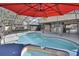 A screened-in pool features an attached spa, bright blue water, a gray deck, and a covered lanai at 725 Briarcrest Dr, Orange City, FL 32763