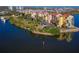 An aerial view shows waterfront condominiums, surrounded by water and lush landscaping at 732 Marina Point Dr # 7320, Daytona Beach, FL 32114