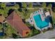 Aerial view of a community pool, showing the pool layout, nearby lounge areas, and lush greenery at 732 Marina Point Dr # 7320, Daytona Beach, FL 32114