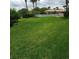 Spacious backyard with manicured lawn, partial fence, and distant community amenities at 732 Marina Point Dr # 7320, Daytona Beach, FL 32114