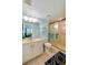 Bright bathroom with a glass shower door, vanity with marble countertop, and stylish blue accents at 732 Marina Point Dr # 7320, Daytona Beach, FL 32114