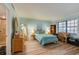 Serene bedroom with wood-look floors, a comfortable bed, and plenty of natural light at 732 Marina Point Dr # 7320, Daytona Beach, FL 32114