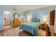 Light-filled bedroom with wood floors, complemented by coastal-themed furnishings and calming blue walls at 732 Marina Point Dr # 7320, Daytona Beach, FL 32114