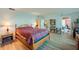 Bright bedroom with wood-look floors, a cozy bed, built-in shelving, and a view into the home at 732 Marina Point Dr # 7320, Daytona Beach, FL 32114
