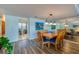 Dining area featuring wood floors, oval table, and decorative wall mirror at 732 Marina Point Dr # 7320, Daytona Beach, FL 32114