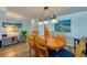 Dining area with wood floors, oval table, and views of colorful wall art at 732 Marina Point Dr # 7320, Daytona Beach, FL 32114