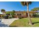 Charming single-story home with a wheelchair ramp, well-kept landscaping, and a brick walkway at 732 Marina Point Dr # 7320, Daytona Beach, FL 32114