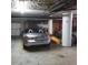 Well-lit garage space featuring a convertible car, kayak, storage cabinets, and a numbered support beam at 732 Marina Point Dr # 7320, Daytona Beach, FL 32114