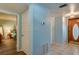 Light blue hallway with doorways leading to a bedroom and a wood-look front door at 732 Marina Point Dr # 7320, Daytona Beach, FL 32114