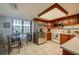 Bright eat-in kitchen featuring stainless steel appliances, wooden cabinets, and a glass-top dining table at 732 Marina Point Dr # 7320, Daytona Beach, FL 32114