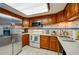 Bright kitchen featuring stainless steel appliances, wooden cabinets, and tiled flooring at 732 Marina Point Dr # 7320, Daytona Beach, FL 32114