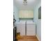 Convenient laundry room with a washer, dryer, and overhead storage at 732 Marina Point Dr # 7320, Daytona Beach, FL 32114