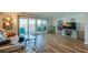 Bright living room with wood floors, a balcony, and views of the water at 732 Marina Point Dr # 7320, Daytona Beach, FL 32114