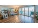 Bright living room features a reclining sofa, wood floors, and sliding glass doors to the balcony at 732 Marina Point Dr # 7320, Daytona Beach, FL 32114