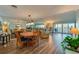 Open-concept living and dining area with wood floors and sliding glass doors to the balcony at 732 Marina Point Dr # 7320, Daytona Beach, FL 32114