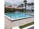 Community pool surrounded by lush landscaping and palm trees with ample seating for residents at 732 Marina Point Dr # 7320, Daytona Beach, FL 32114