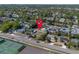 Aerial view of the home in a neighborhood with lush greenery and tennis courts at 852 Derbyshire Rd, Daytona Beach, FL 32117