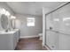 Updated bathroom with double vanity, modern fixtures, and a sleek glass shower enclosure at 852 Derbyshire Rd, Daytona Beach, FL 32117