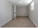 Bedroom featuring neutral carpet, a window, and ample lighting at 852 Derbyshire Rd, Daytona Beach, FL 32117