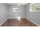 Bedroom featuring two windows for natural light and warm wood-look flooring at 852 Derbyshire Rd, Daytona Beach, FL 32117
