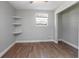 Bedroom featuring wood-look flooring, a closet, and stylish shelving at 852 Derbyshire Rd, Daytona Beach, FL 32117
