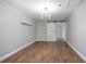 Bedroom with stylish chandelier lighting and floating shelves, plus a sliding barn door at 852 Derbyshire Rd, Daytona Beach, FL 32117