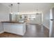 Open-concept living space with wood floors, island seating, and lots of natural light at 852 Derbyshire Rd, Daytona Beach, FL 32117