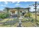 Charming backyard featuring a pergola-covered patio, lush greenery, and inviting outdoor seating at 3430 Arabesque Dr, Deland, FL 32724