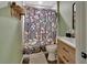 Full bathroom featuring a modern vanity, decorative mushroom-themed shower curtain, and dark tile flooring at 3430 Arabesque Dr, Deland, FL 32724