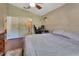 Bright bedroom featuring a ceiling fan, wood floors, and desk area perfect for a home office at 3430 Arabesque Dr, Deland, FL 32724