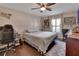 Cozy bedroom featuring dark wood floors, a ceiling fan, and natural light from the window at 3430 Arabesque Dr, Deland, FL 32724