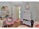 Cute bedroom featuring hardwood floors, a desk with shelves, and a unique Hello Kitty chair at 3430 Arabesque Dr, Deland, FL 32724