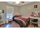Inviting bedroom featuring wood flooring, a comfortable bed, and a vanity space at 3430 Arabesque Dr, Deland, FL 32724