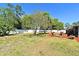 Expansive backyard with mature trees and manicured lawn, offering plenty of space and greenery at 10 Lilac Dr, Debary, FL 32713