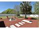 Large backyard featuring a fire pit, grill, seating and landscaping, ideal for outdoor gatherings at 10 Lilac Dr, Debary, FL 32713