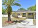 Beautiful home with a carport, well-manicured lawn, and a beautiful palm tree and garden, perfect for a comfortable lifestyle at 10 Lilac Dr, Debary, FL 32713