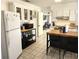 Functional kitchen featuring white cabinets, butcher block island, and stainless steel appliances, perfect for cooking at 10 Lilac Dr, Debary, FL 32713