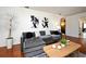 Stylish living room featuring a plush gray sectional, modern art, and warm wood floors creating a cozy atmosphere at 10 Lilac Dr, Debary, FL 32713