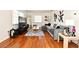 Bright and open living room featuring hardwood floors, a comfortable gray sofa, a large TV, and stylish décor at 10 Lilac Dr, Debary, FL 32713