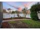 Landscaped backyard featuring a brick walkway, flower garden, and a white privacy fence at 104 W Lake Victoria Cir, Deland, FL 32724