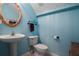 Charming half bath with pedestal sink and stylish blue accents at 104 W Lake Victoria Cir, Deland, FL 32724